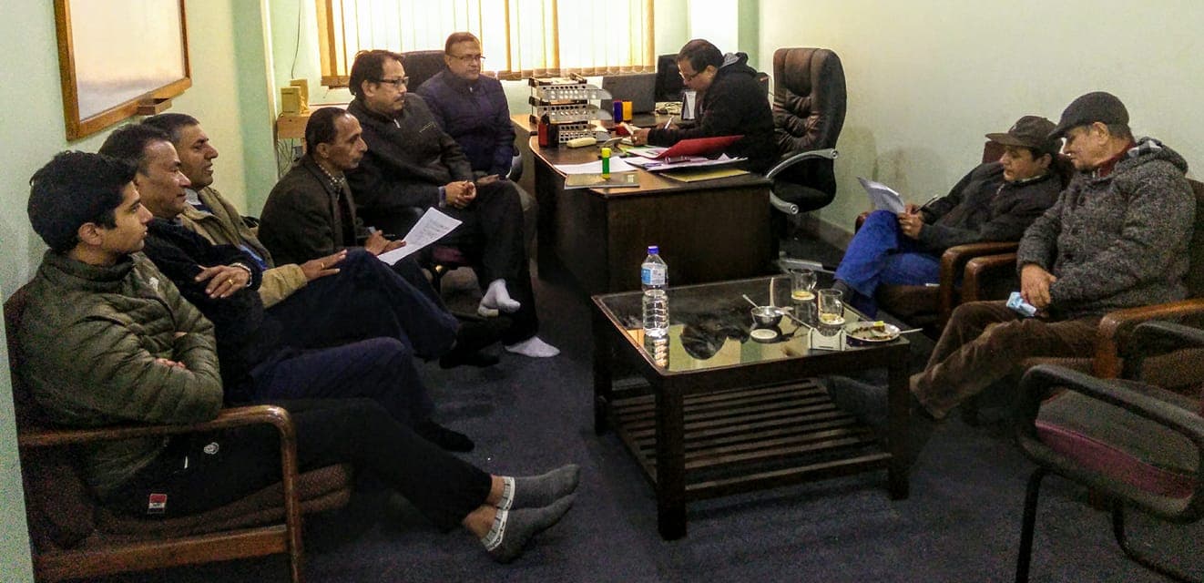 Participants gathered for a meeting in an office lounge