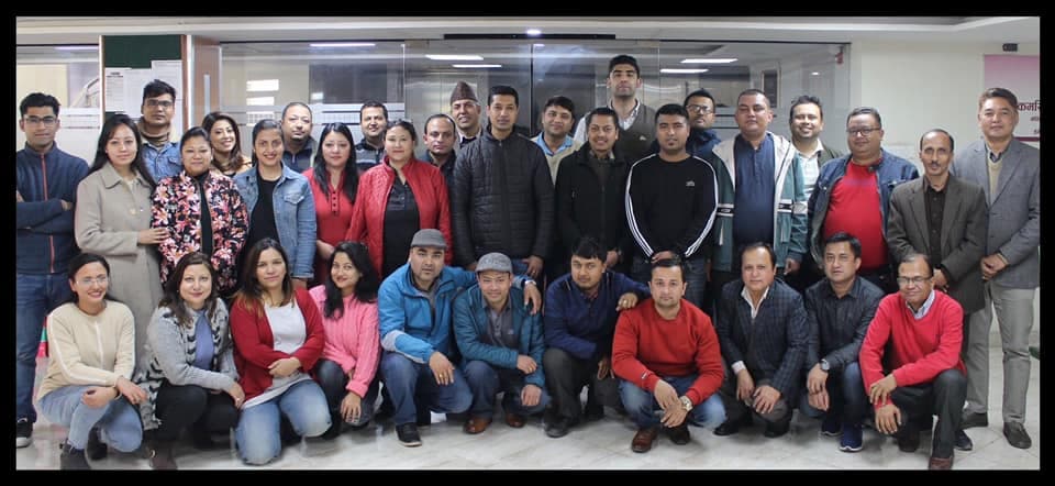 A large group of training participants posing together