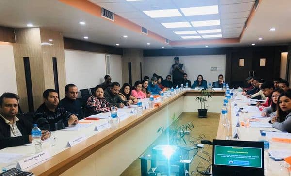 Training participants seated around a long conference table