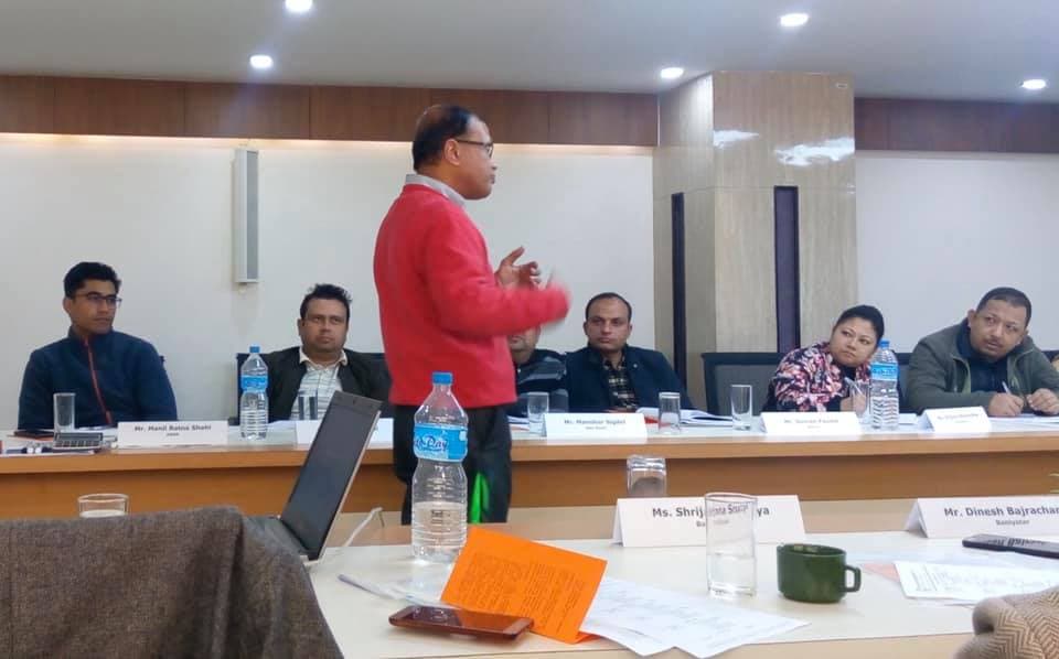 A facilitator presenting to participants in a conference room
