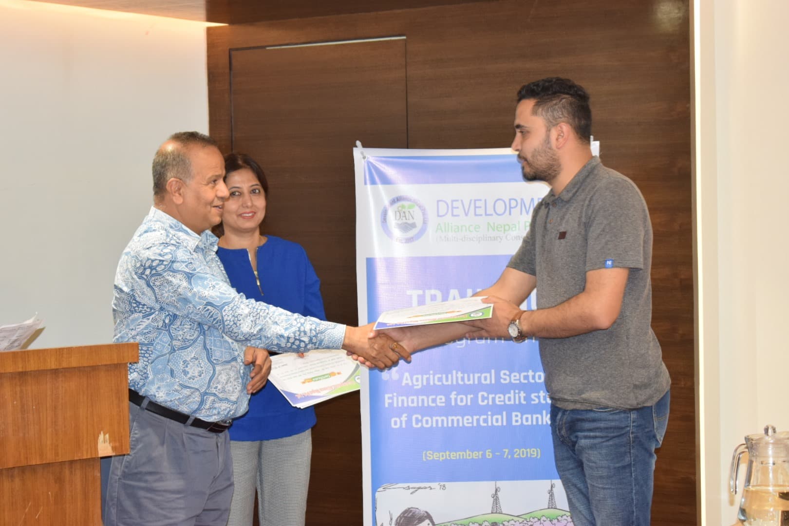 A participant receiving a certificate during a training program