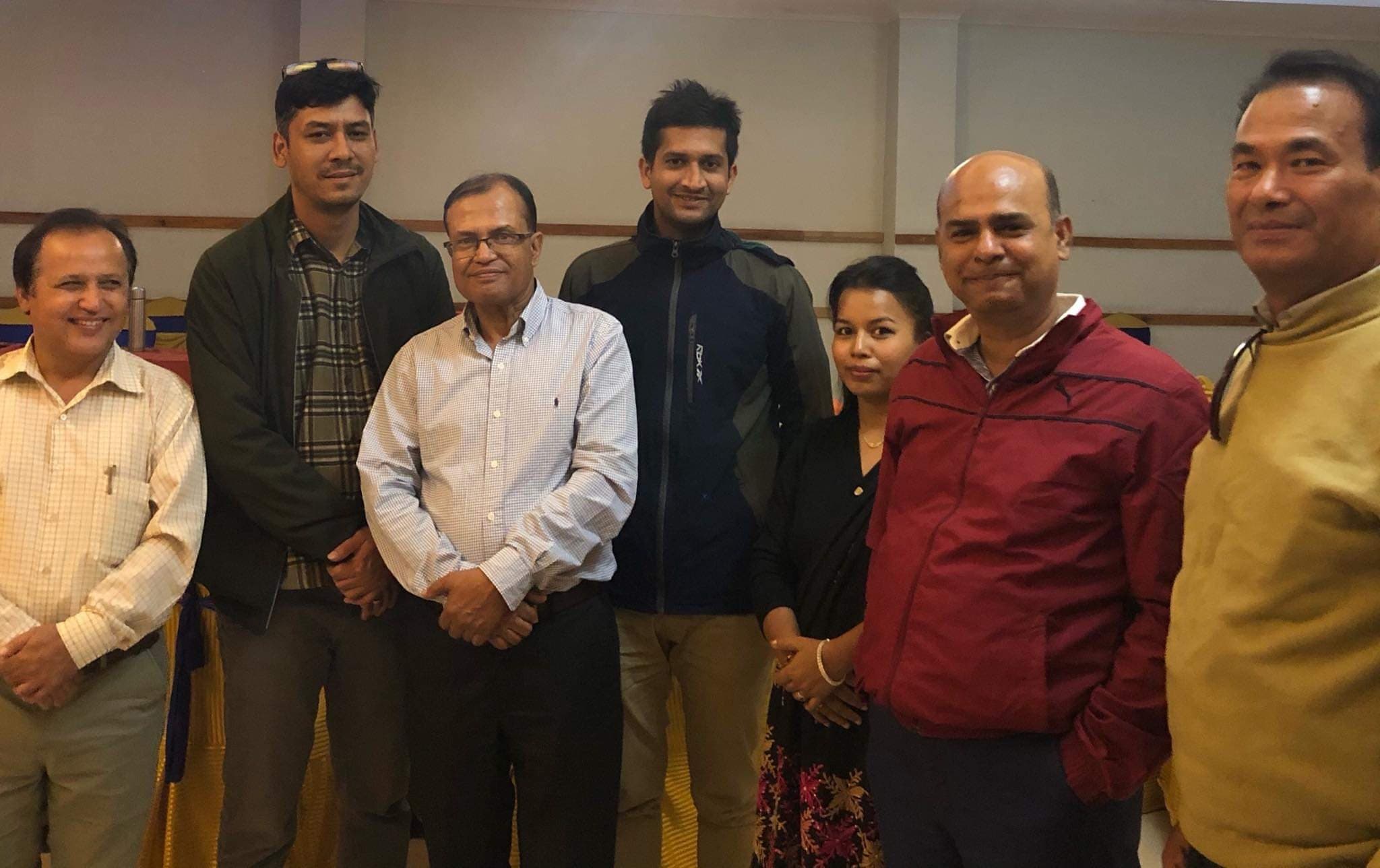 A small group standing together indoors after a training session