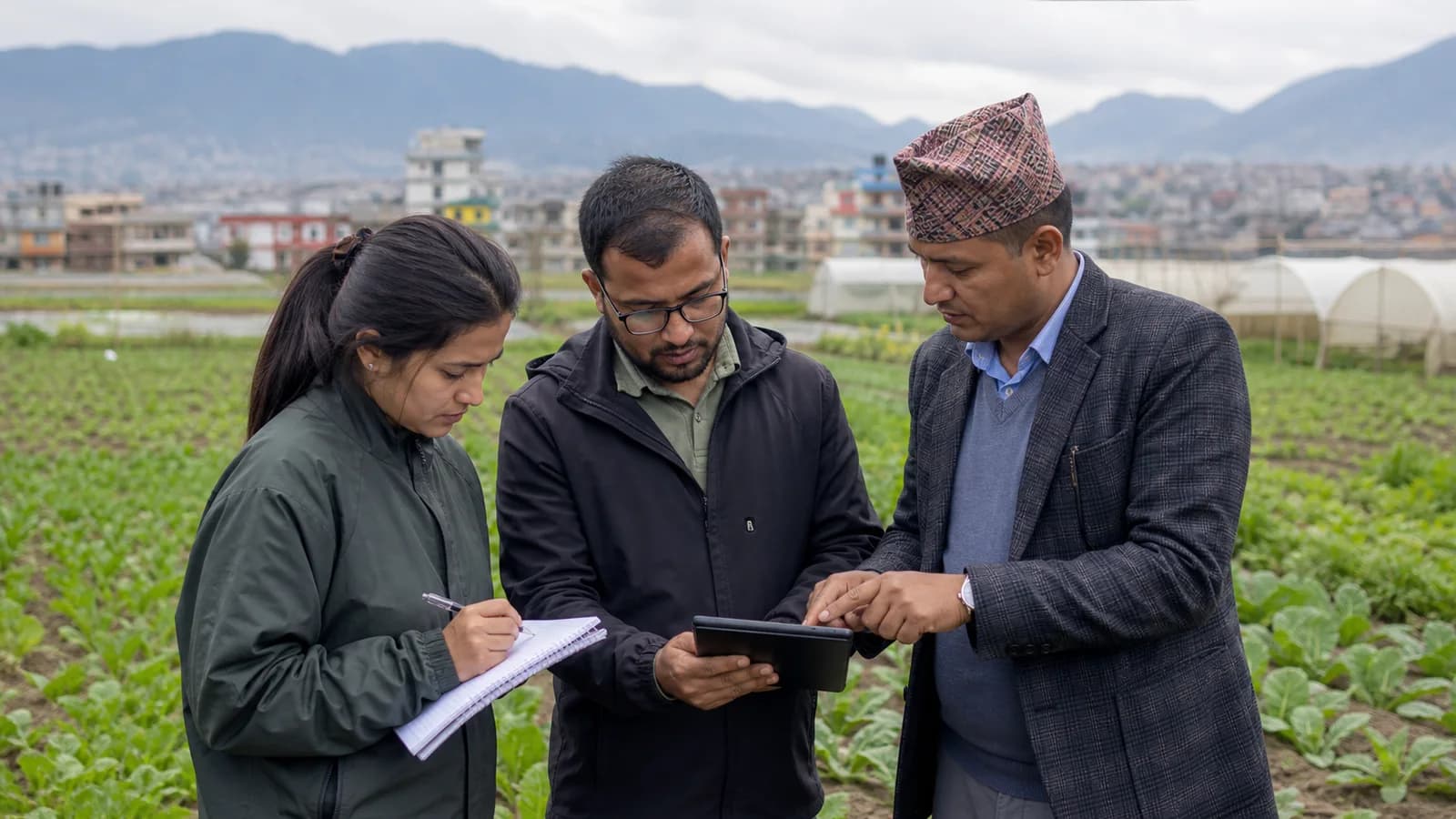 Nepalese professionals reviewing field information at a farm